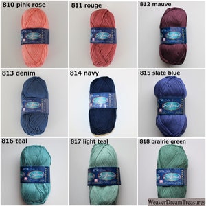 Puede incluir: Nueve ovillos de hilo en varios colores, incluyendo rosa palo, rojo, malva, denim, azul marino, azul pizarra, verde azulado, verde azulado claro y verde pradera. Cada ovillo tiene una etiqueta blanca con la palabra "Sinfonia" impresa en ella.
