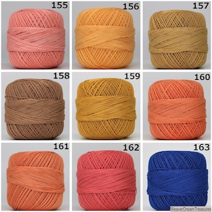 May include: Nine balls of yarn in various colors, including peach, orange, brown, yellow, and blue. Each ball is labeled with a number from 155 to 163.