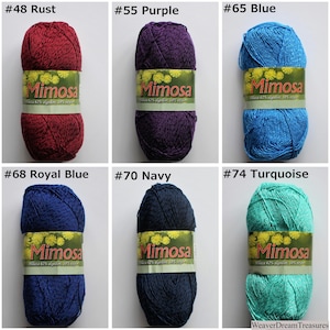 May include: Six balls of Mimosa yarn in a range of colours, including rust, purple, blue, royal blue, navy and turquoise. Each ball has a label with the brand name "Mimosa" and the colour number.