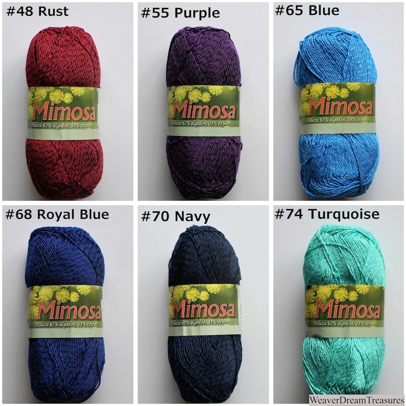 May include: Six balls of Mimosa yarn in a range of colours, including rust, purple, blue, royal blue, navy and turquoise. Each ball has a label with the brand name "Mimosa" and the colour number.