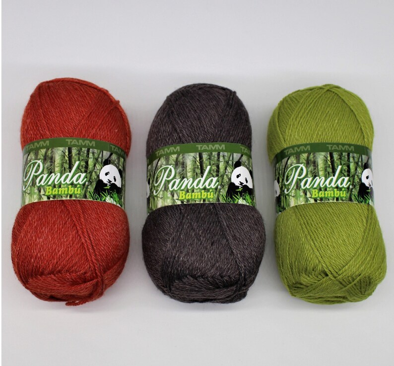 May include: Three skeins of yarn in red, brown, and green. Each skein has a label that says "Panda Bambu" with a panda bear illustration.