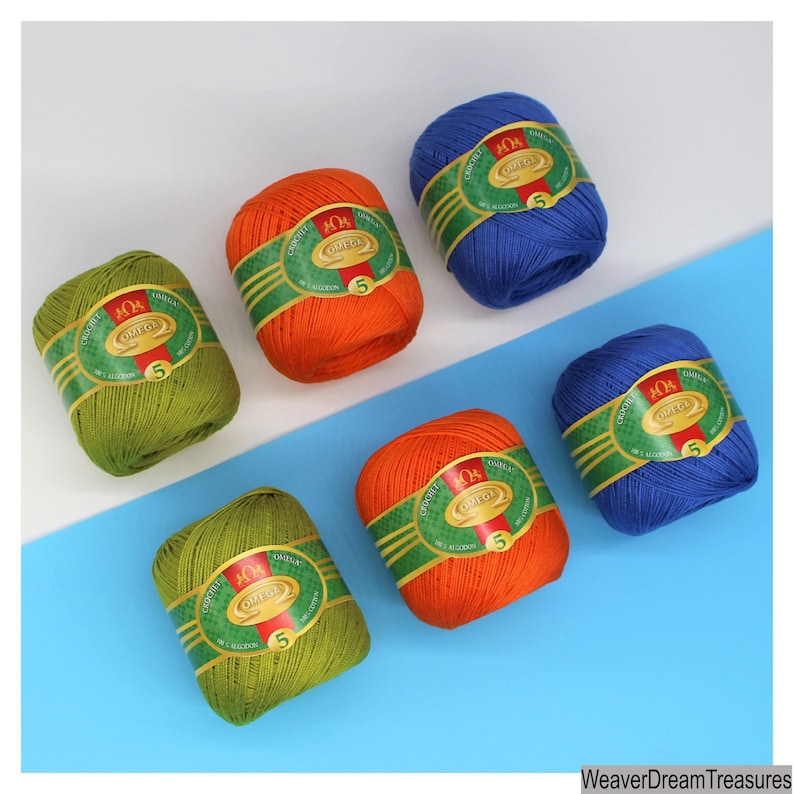 May include: Six balls of yarn in various colors, including green, orange, and blue. Each ball has a label that reads "Crochet 40/4 Omega 5".