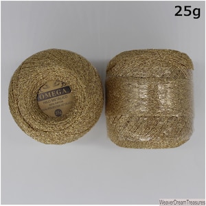 May include: Two spools of gold metallic thread, each labeled "OMEGA HILO METALICO 65% RAYON 35% POLYESTER METALICO 25g".