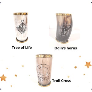 May include: Three drinking horns with gold rims and different engraved designs. The horns are labeled "Tree of Life", "Odin's horns", and "Troll Cross".