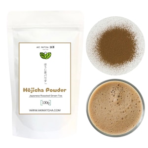 May include: A white bag of hojicha powder, a Japanese roasted green tea. The bag has a label with the text "AKI MATCHA 抹茶", "ほうじ茶パウダー", "Hojicha Powder", "Japanese Roasted Green Tea", "[100g]" and "WWW.AKIMATCHA.COM". There is a small bowl of the powder and a glass of hojicha tea.