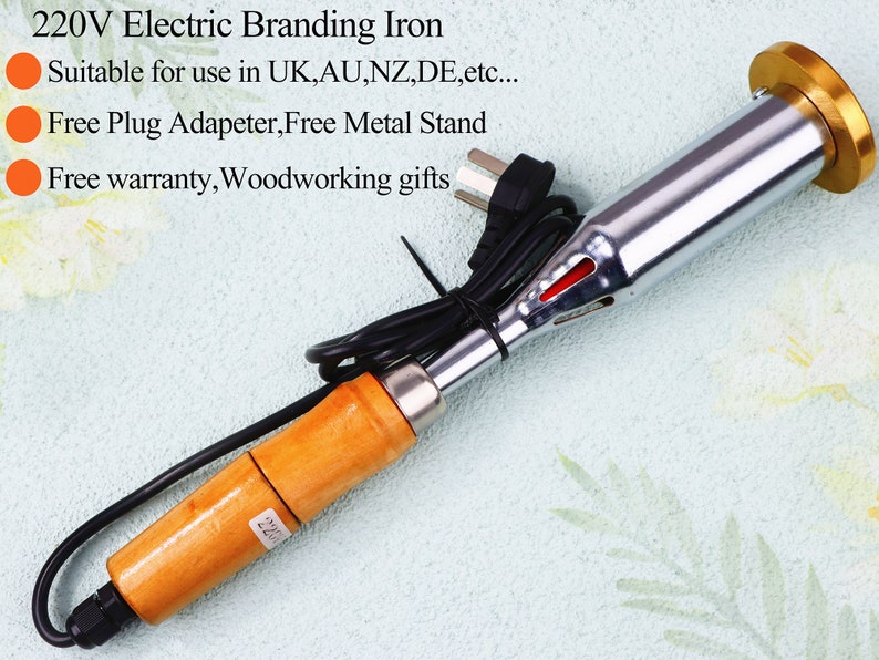 May include: A 220V electric branding iron with a wooden handle and a metal heating element. The iron has a gold-colored tip and a black power cord. The text "220" is visible on the handle.