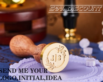May include: A gold-toned wax seal stamp with a floral design and the initials "J112" engraved on the face. The stamp is attached to a wooden handle. The text "SEND ME YOUR LOGO, INITIAL, IDEA" is visible at the bottom of the image.