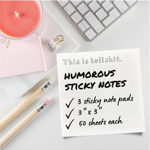 May include: A square white sticky note with black text that reads: This is bullshit. HUMOROUS STICKY NOTES, 3 sticky note pads, 3 inches by 3 inches, 50 sheets each. The note is accompanied by two wooden pencils with pink erasers.