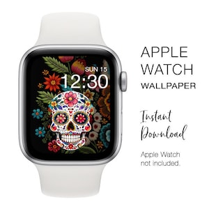 Puede incluir: Un Apple Watch blanco con una esfera negra que muestra la hora 12:30 y la fecha DOM 15. La esfera del reloj presenta un diseño de calavera de azúcar colorido con detalles florales.