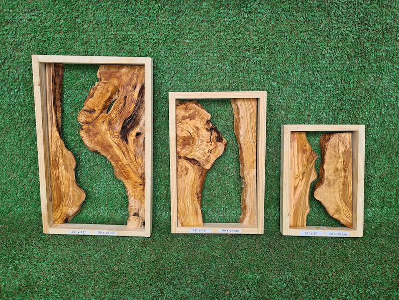 May include: Three wooden frames with natural wood grain and a unique, organic, wood-shaped design inside. The frames are different sizes: 20 x 12 inches, 16 x 10 inches, and 12 x 8 inches.