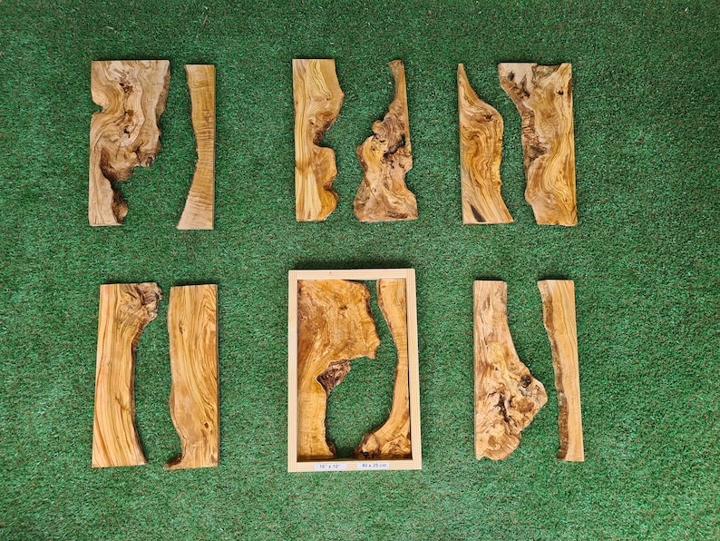 May include: Assortment of eight wood pieces with natural wood grain and unique shapes. The pieces are arranged on a green surface.