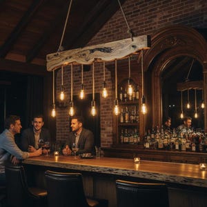 May include: A dimly lit bar with a rustic wooden countertop and a decorative light fixture. The bar features a large mirror and shelves stocked with bottles. Three people are seated at the bar, enjoying drinks.