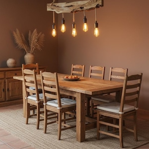 May include: A rustic dining room set with a large wooden table and six matching chairs. A unique light fixture hangs above the table, featuring exposed light bulbs suspended from a wooden beam. The room has a warm, inviting atmosphere with a neutral color palette.