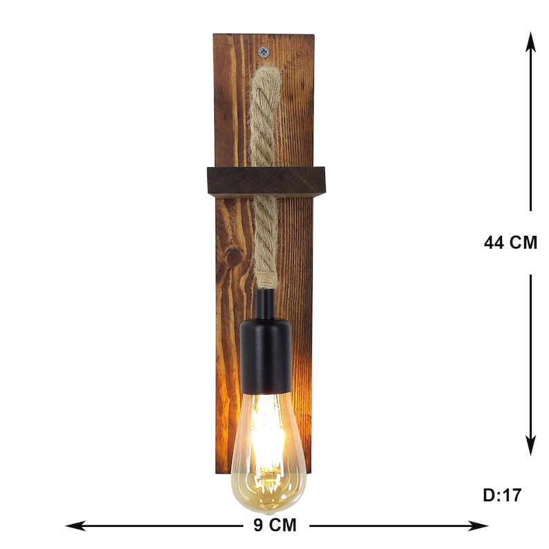 May include: A wall-mounted light fixture featuring a dark brown stained wooden backplate with a small shelf, a thick beige rope cord, and a black metal socket holding a glowing Edison-style light bulb. The fixture measures 44 cm by 9 cm by 17 cm.