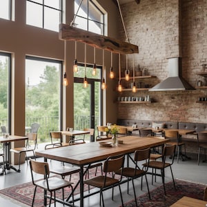 May include: Interior shot of a rustic dining area with a large wooden table and chairs. A unique light fixture made from a wooden beam hangs above. The room features exposed brick walls, large windows, and patterned rugs.