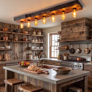 May include: A kitchen island with a concrete countertop, two wooden stools, and a wooden base. Above, a rectangular wooden beam light fixture holds six Edison-style bulbs. A stack of books with the word KITAP on the spine sits on a shelf.
