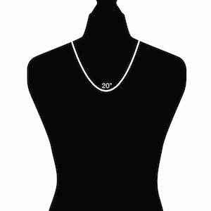 May include: A white necklace on a black mannequin. The necklace is 20 inches long.