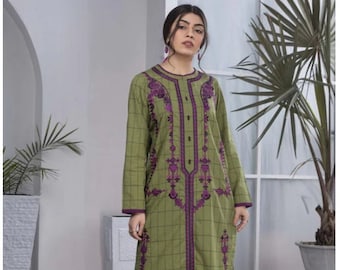 May include: Olive green long tunic with a purple embroidered design and a button-up front. The tunic has a checkered pattern and is paired with black pants and black heels. The outfit is suitable for casual or semi-formal occasions.