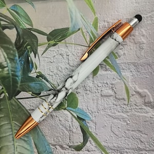 Balpen in marmerdesign met naamgravure, een bijzonder cadeau in een fluwelen etui. Gemaakt van metaal met elegante koperen accenten.