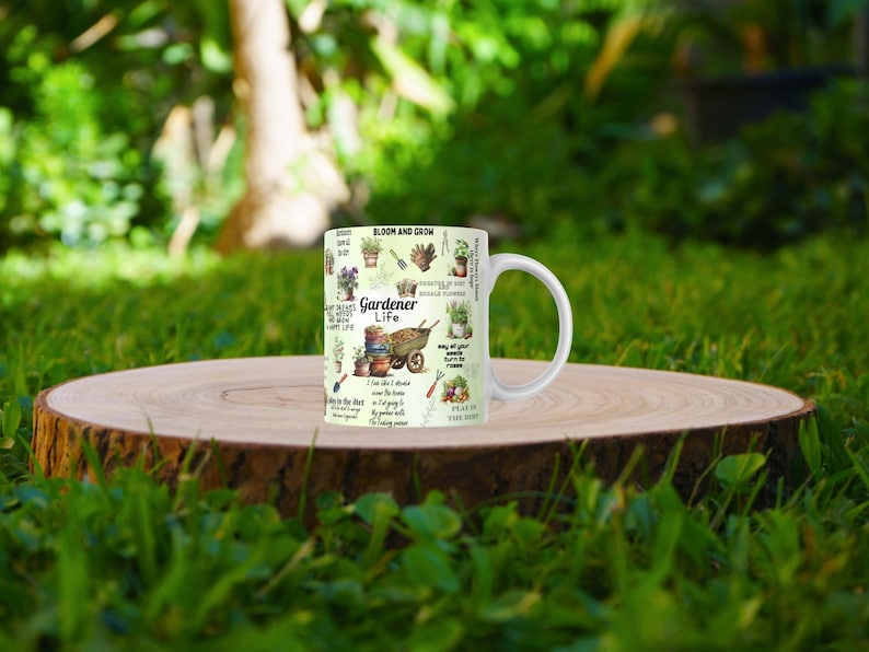 May include: White ceramic mug with a green and brown design featuring gardening-themed illustrations and text that reads "Bloom and Grow", "Gardener Life", and "Plant the Seed".