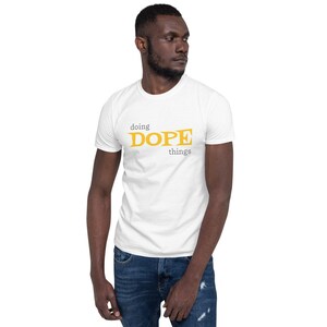May include: White t-shirt with a yellow graphic that says "doing DOPE things".