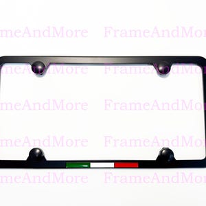 May include: Black license plate frame with a decorative Italian flag design. The frame has a rectangular shape with rounded corners and four black mounting hardware pieces. The Italian flag is green, white, and red.