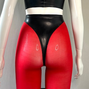 May include: A black and red latex bodysuit with a high-waisted, form-fitting design. The bodysuit features a black latex panel at the front and red fabric on the legs.