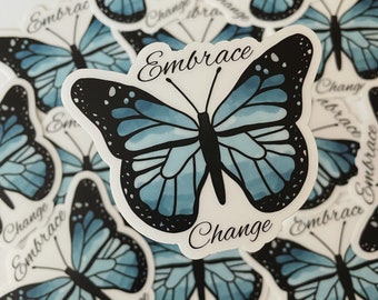 May include: A sticker with a blue watercolor butterfly with black outlines and the text "Embrace Change" in black cursive.