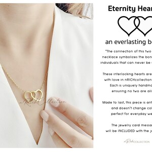 May include: Gold necklace with two interlocking heart charms. The necklace is on a model's neck. The text "Eternity Hearts" and "an everlasting bond" is on the image. The text "The connection of this two hearts necklace symbolizes the bond of two individuals that can never be undone." is also on the image.