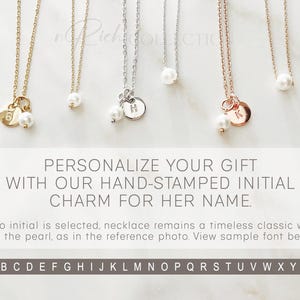 May include: Three delicate necklaces with a pearl and a small charm. The charms are hand-stamped with the letters H, K, and a number 6. The text below the necklaces reads "PERSONALIZE YOUR GIFT WITH OUR HAND-STAMPED INITIAL CHARM FOR HER NAME."  The text below that reads "If no initial is selected, necklace remains a timeless classic with just the pearl, as in the reference photo. View sample font below." The alphabet is displayed below the text.