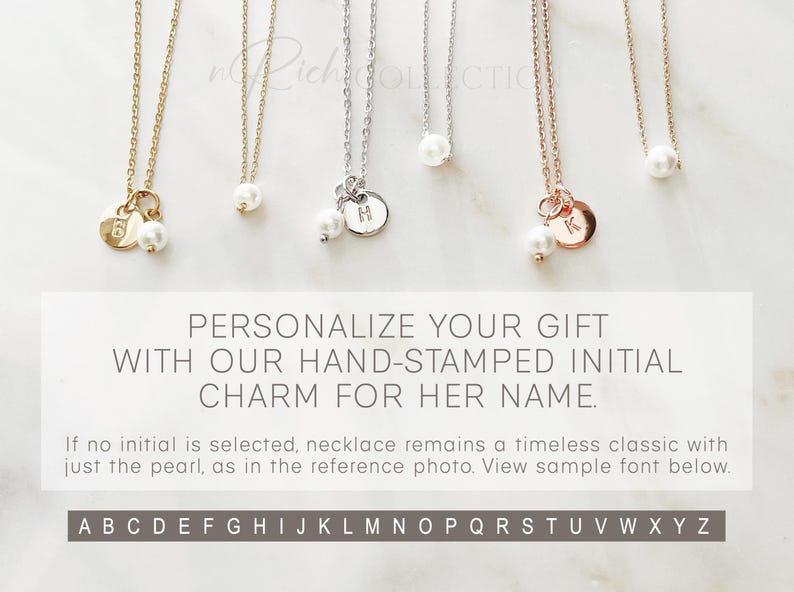 May include: Three delicate necklaces with a pearl and a small charm. The charms are hand-stamped with the letters H, K, and a number 6. The text below the necklaces reads "PERSONALIZE YOUR GIFT WITH OUR HAND-STAMPED INITIAL CHARM FOR HER NAME."  The text below that reads "If no initial is selected, necklace remains a timeless classic with just the pearl, as in the reference photo. View sample font below." The alphabet is displayed below the text.