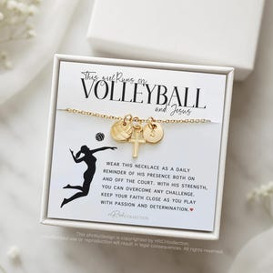 May include: A gold necklace with a volleyball charm, a cross charm, and a letter charm. The necklace is displayed on a white card with the text "This girl runs on volleyball and Jesus".