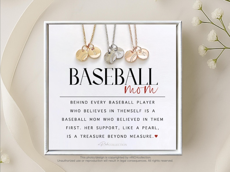 May include: A white card with the text "BASEBALL mom" in black lettering. The card has a quote about baseball moms and a small red heart. Three necklaces with baseball charms are displayed on the card.