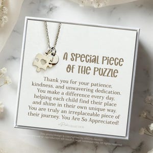 May include: A silver puzzle piece necklace with a heart cutout on a white card with the text "A Special Piece of the Puzzle" and a message thanking someone for their patience, kindness, and dedication. The message says "You are truly an irreplaceable piece of their journey. You Are So Appreciated!"