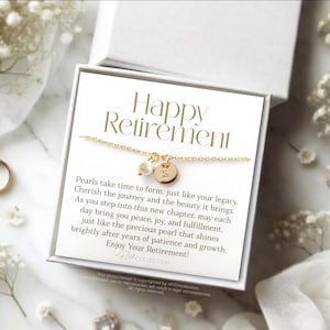 May include: A white gift box with a gold necklace inside. The box has a card that reads "Happy Retirement" and a message about pearls.