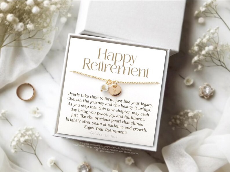 May include: A white gift box with a gold necklace inside. The box has a card that reads "Happy Retirement" and a message about pearls.