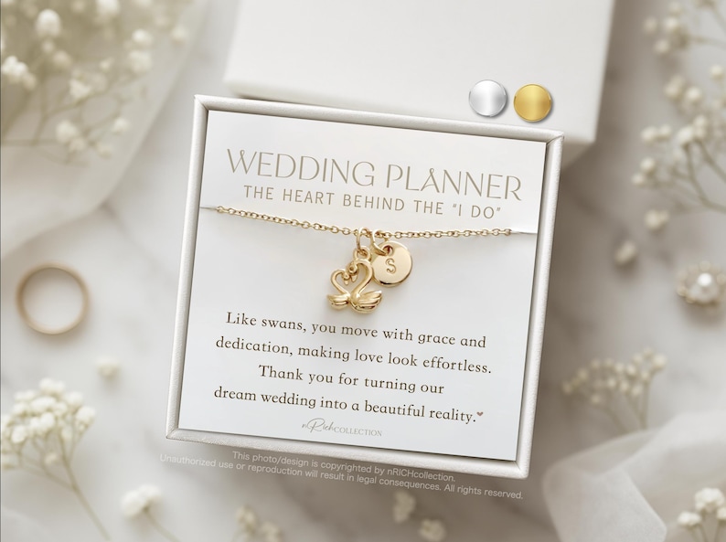 May include: A gold-colored necklace with swan charms and a personalized initial pendant, presented in a white gift box. The card reads "Wedding Planner" and includes a thank you message. The background features wedding-themed decorations.