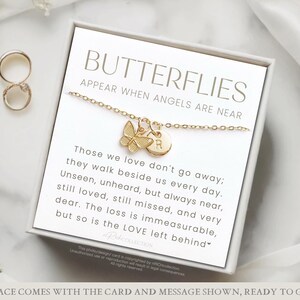 May include: A gold butterfly necklace with a charm that says "R" on a white card with the text "Butterflies Appear When Angels Are Near" and a message about those we love don't go away, they walk beside us every day.