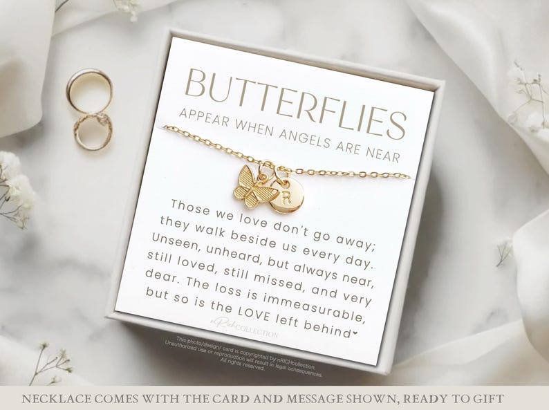 May include: A gold butterfly necklace with a charm that says "R" on a white card with the text "Butterflies Appear When Angels Are Near" and a message about those we love don't go away, they walk beside us every day.