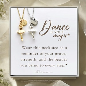 May include: A white gift box with a silver and gold necklace featuring a ballerina charm. The box has a message that reads "Dance is your magic*" and "Wear this necklace as a reminder of your grace, strength, and the beauty you bring to every step."