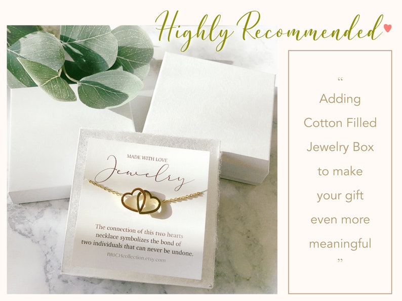 May include: A white jewelry box with a gold necklace featuring two intertwined hearts. The box is filled with white cotton and has a label that reads "Made with Love Jewelry". The connection of this two hearts necklace symbolizes the bond of two individuals that can never be undone. BROCHcollection etsy.com