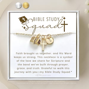 May include: A gold necklace with charms of a cross, an open book, and a letter 'S'. The necklace is displayed on a white card with the text "Bible Study Squad" and a message about faith, love, and scripture.