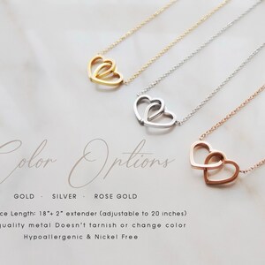 May include: Three delicate necklaces with a double heart pendant in gold, silver, and rose gold. The necklaces are 18 inches long with a 2 inch extender, making them adjustable to 20 inches. The necklaces are made of high-quality metal that doesn't tarnish or change color. They are hypoallergenic and nickel-free.