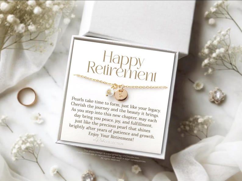 May include: A white gift box with a gold necklace inside. The box has a card that reads "Happy Retirement" and a message about pearls.