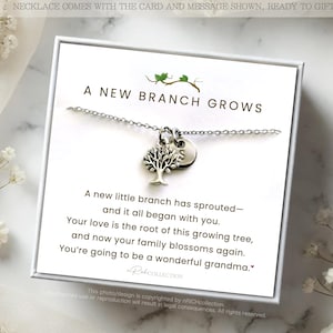 May include: A silver necklace with a tree pendant and a small charm, presented on a white card with the text "A New Branch Grows." The card includes a message about family and new beginnings, with floral accents.