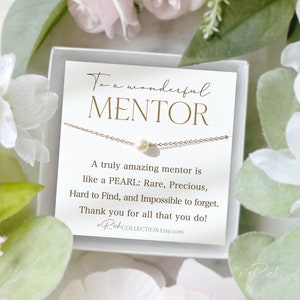 May include: A white card with gold lettering reads "To a wonderful MENTOR. A truly amazing mentor is like a PEARL: Rare, Precious, Hard to Find, and Impossible to forget. Thank you for all that you do!"  A delicate gold chain necklace with a single white pearl pendant is displayed on the card.