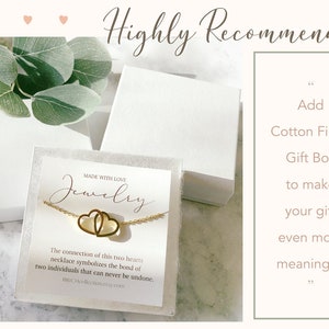 May include: A gold necklace with two interlocking hearts on a white card with the text "Made with Love, Jewelry". The card also includes the text "The connection of this two hearts necklace symbolizes the bond of two individuals that can never be undone.  TheCHcollectometry.com". The necklace is in a white gift box. The text "Highly Recommended" is at the top of the image. The text "Add Cotton Filled Gift Box to make your gift even more meaningful" is on the right side of the image.