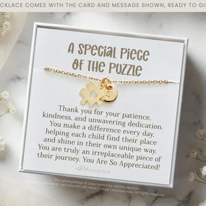 May include: A white gift box with a gold necklace featuring a puzzle piece charm. The box includes a card with the message "A Special Piece of the Puzzle" and a heartfelt message thanking someone for their patience, kindness, and dedication.