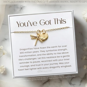 May include: A white card with the text "You've Got This" and a gold dragonfly necklace with a small gold disc charm. The card includes a message about dragonflies symbolizing strength, transformation, and the ability to rise above life's challenges.