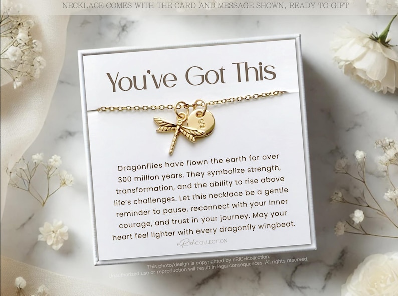 May include: A white card with the text "You've Got This" and a gold dragonfly necklace with a small gold disc charm. The card includes a message about dragonflies symbolizing strength, transformation, and the ability to rise above life's challenges.